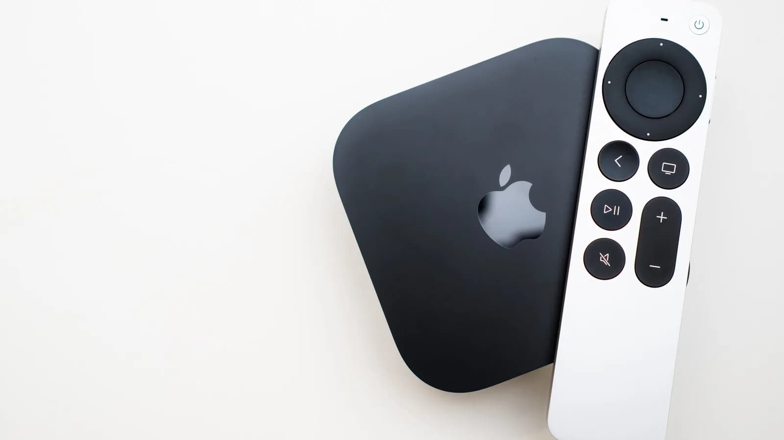 Apple TV 4K streaming box and a PlayStation 5 console shown side by side near a television.