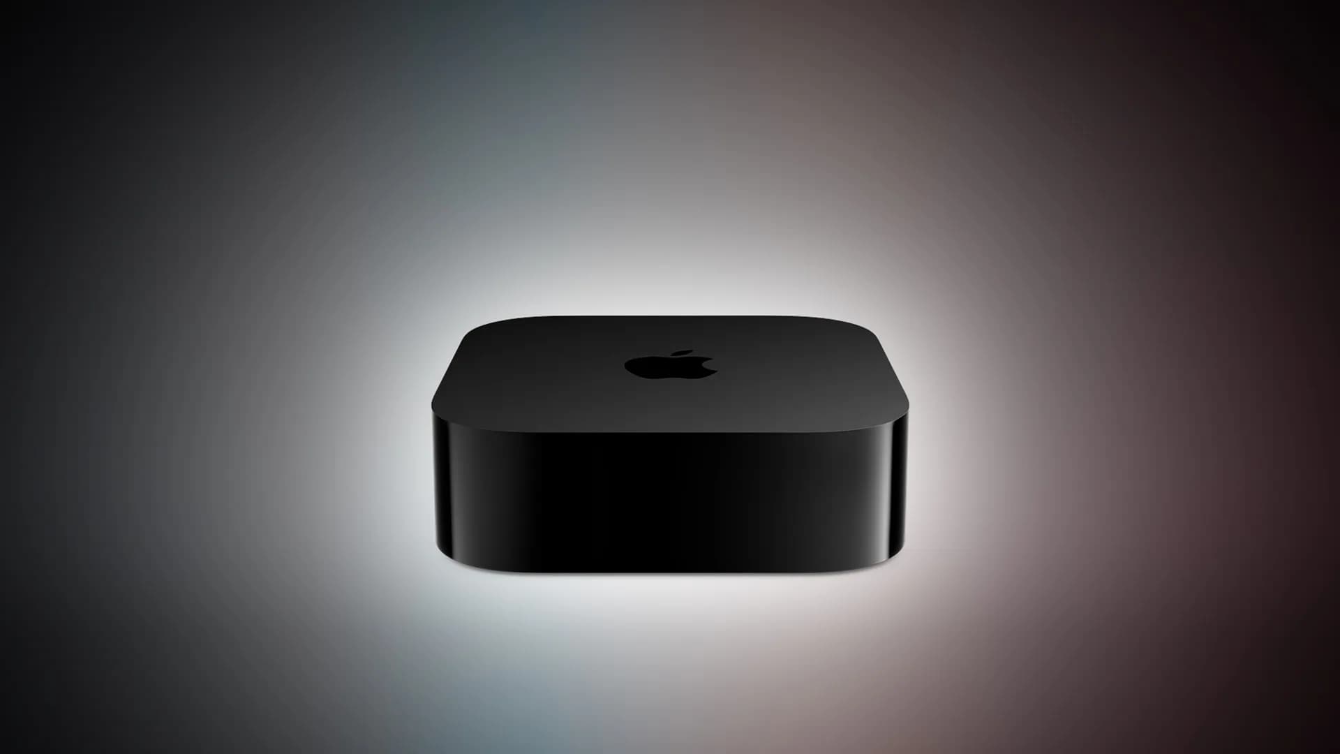 Black Apple TV set-top box resting next to a metallic Siri remote control