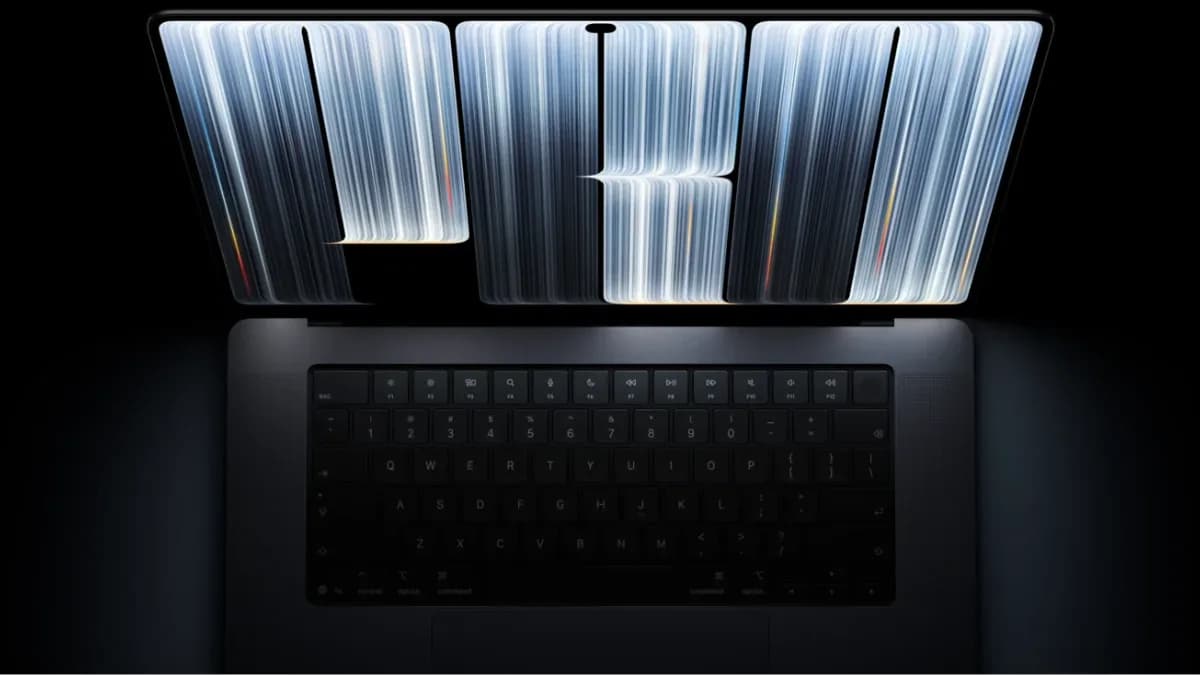 Apple's new MacBook Pro with PROLED XDR touchscreen display shown open with a Dynamic Island cutout at the top of the screen