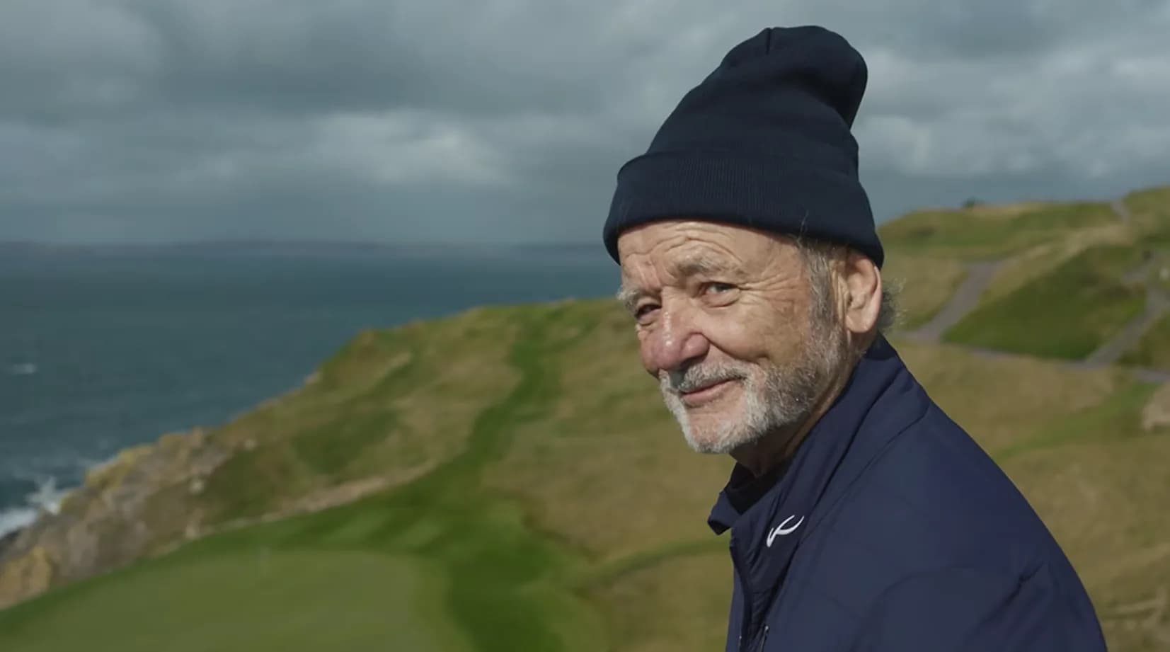 Bill Murray walking on a golf course in Ireland in a promotional image for A Course Called Ireland on Paramount+