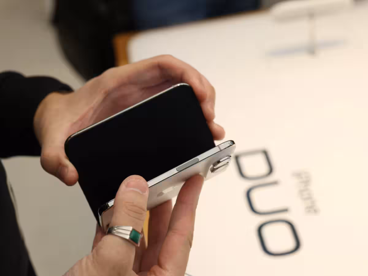 Customers queue outside an Apple Store on the launch day of the iPhone Duo foldable phone.